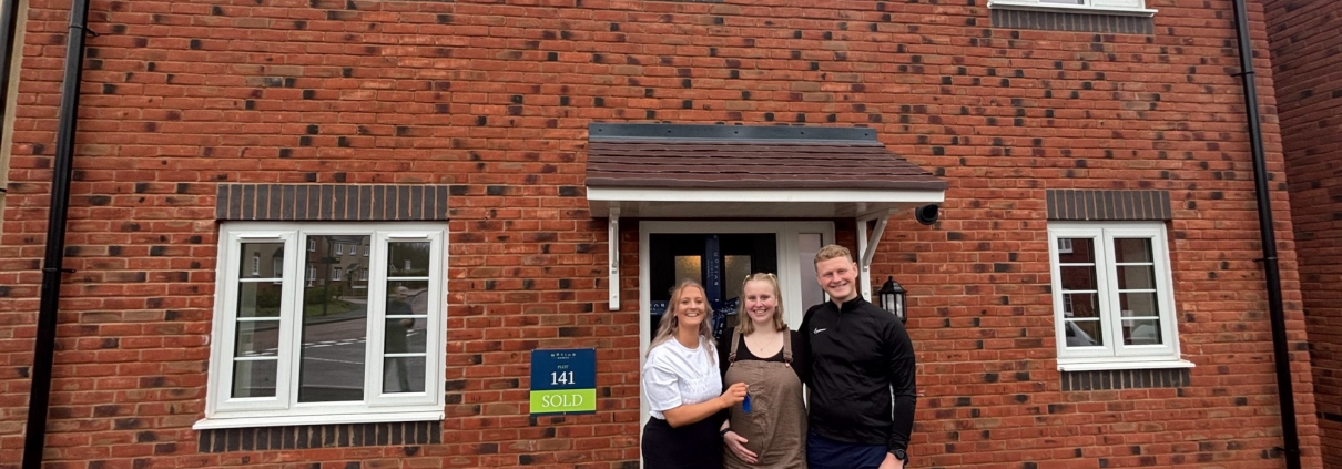 alice and dom infront of their new home